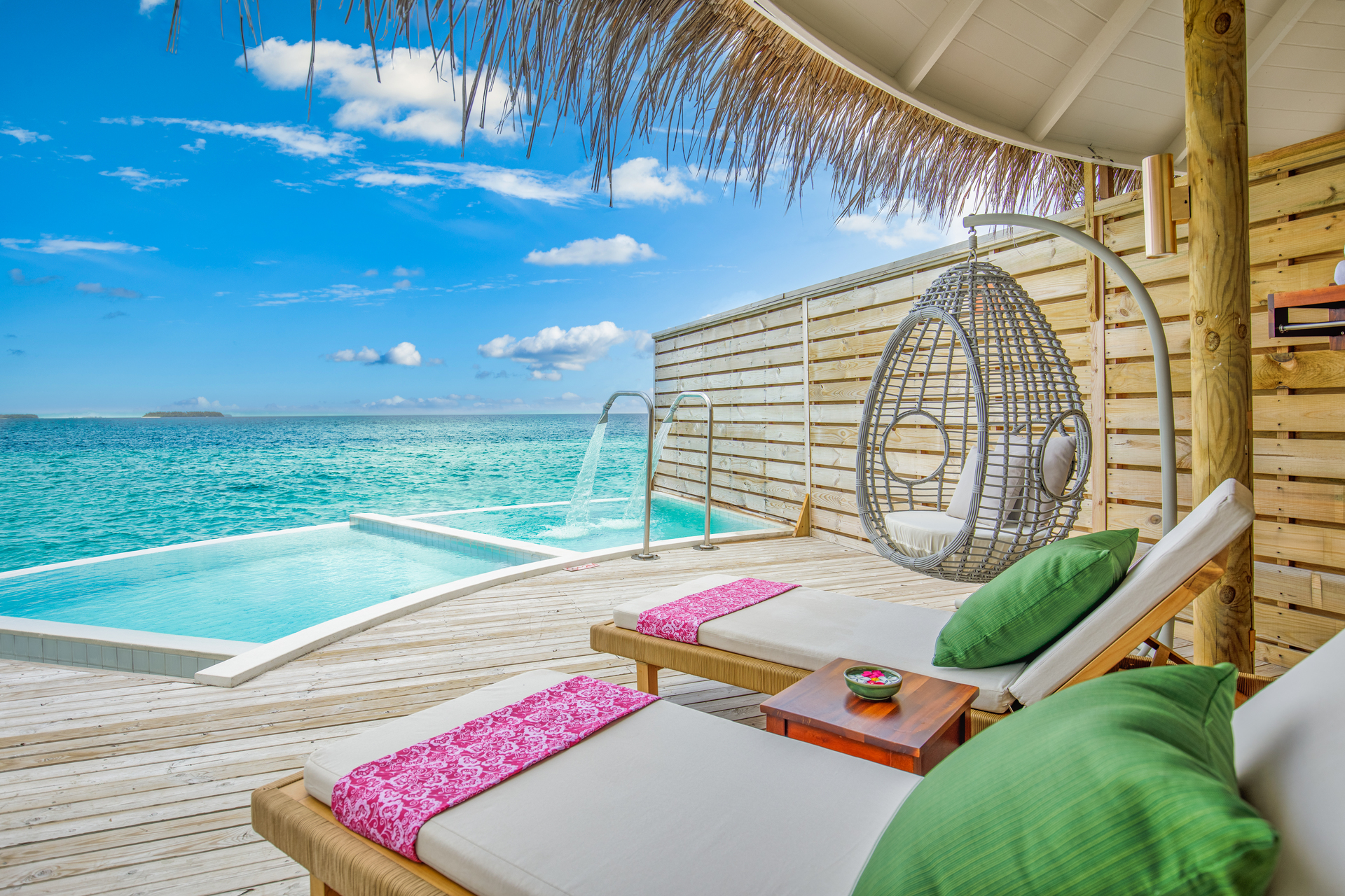 Overwater bungalows reaching out over a calm turquoise South Pacific lagoon