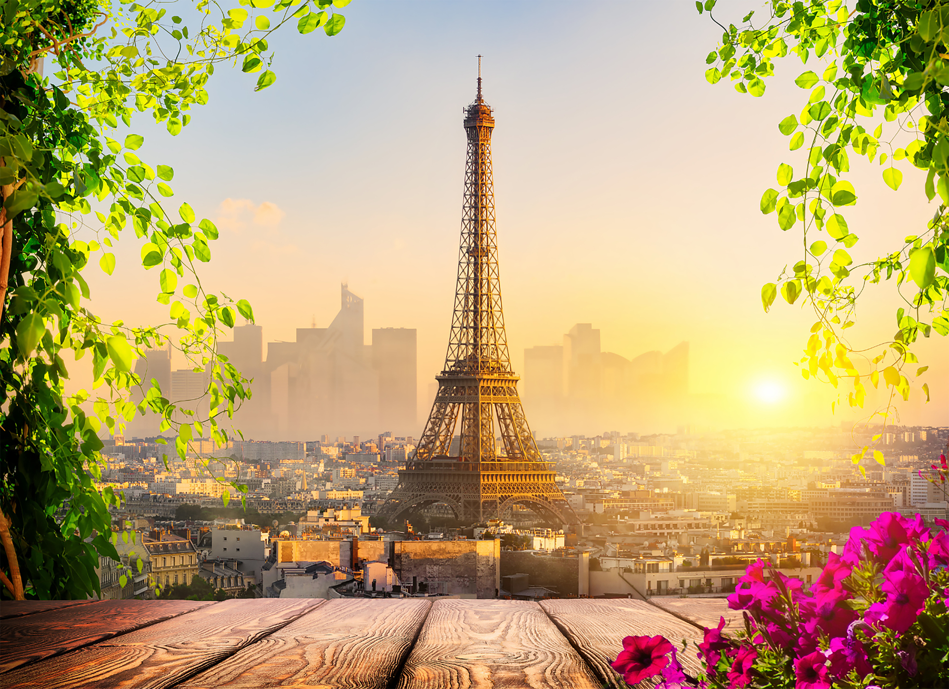 The Eiffel Tower glowing over Paris at dusk